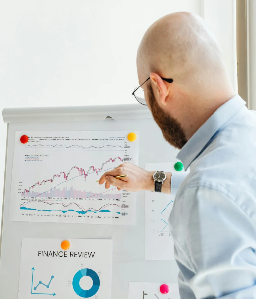Professional discussing financial charts and graphs during a business presentation.