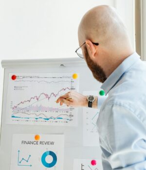 Professional discussing financial charts and graphs during a business presentation.